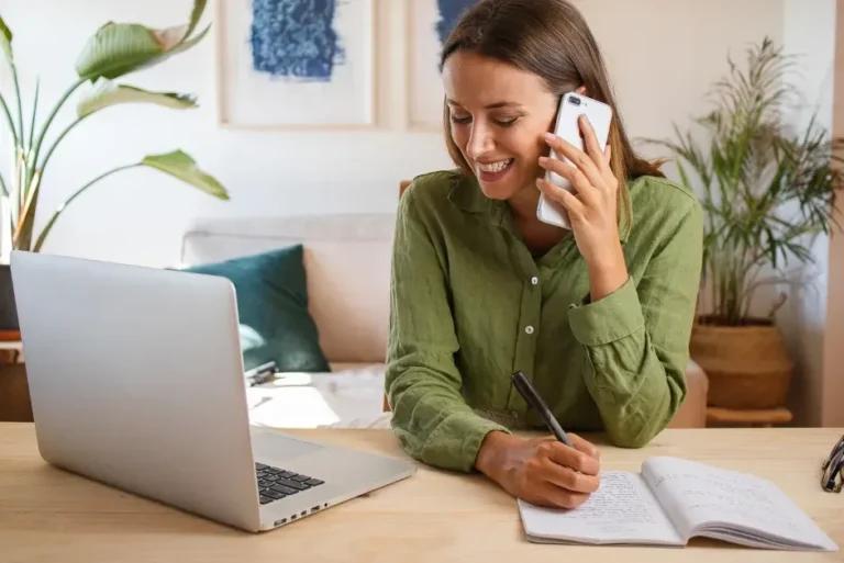 Franchise Marketing 28 Businesswoman on phone managing franchise marketing strategy with laptop and notebook
