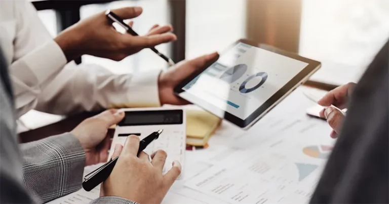 Franchise Marketing 33 Marketing team reviewing franchise performance data and growth analytics on a tablet