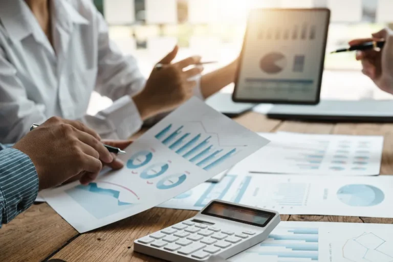 Marketing professionals analyzing PPC performance charts and ROI reports
